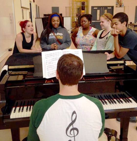 Music Director Eric Rehm plays one of the songs from Rodgers & Hammerstein's "Cinderella" as Rebecca Thompson,  (l to r) Ashley Randle, Taylor Cole, Julia Albrecht and Joshua Houchins practice harmonizing. Image credit: Provided. 